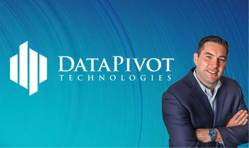 Businessman in navy suit smiling confidently beside the DataPivot Technologies corporate logo
