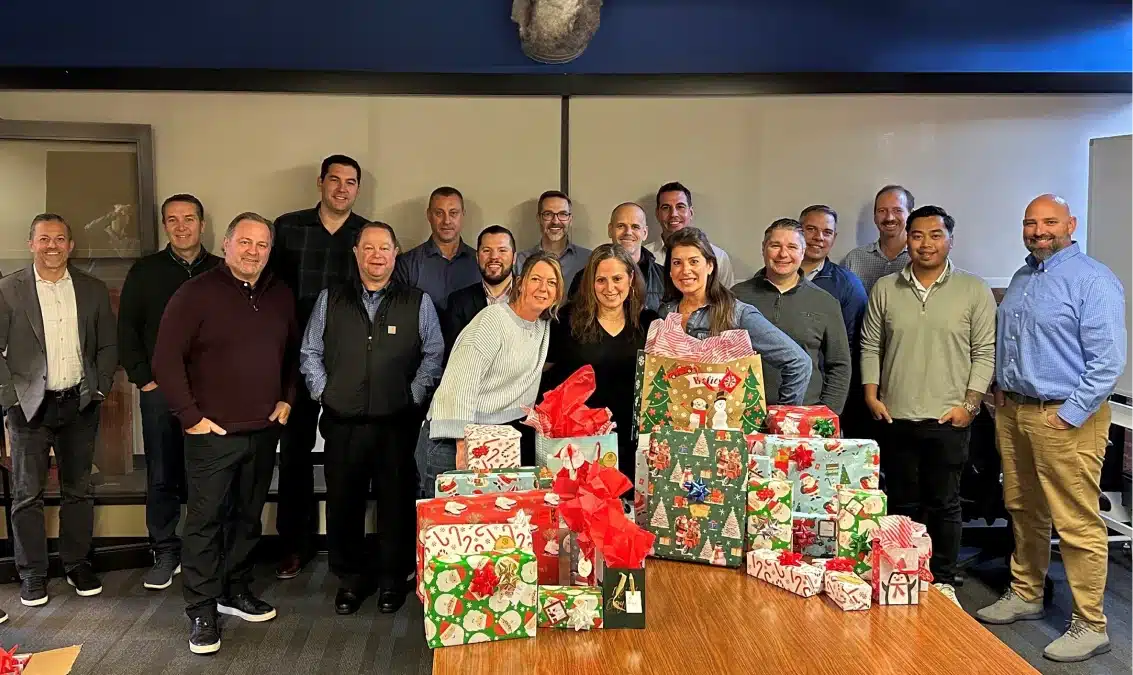 DataPivot team posing with wrapped holiday presents collected for the Project Bethlehem donation drive