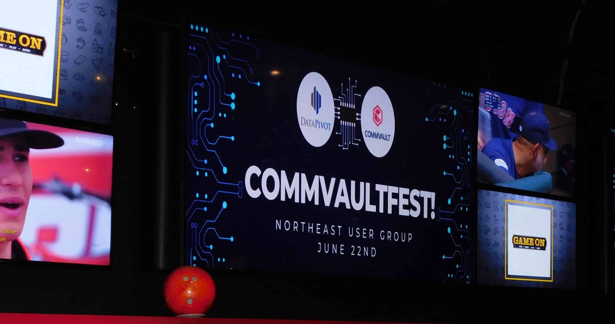 Large event screen displaying CommvaultFest 2023 announcement featuring DataPivot and Commvault logos