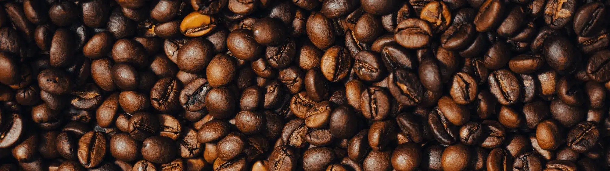 Close-up view of roasted coffee beans showcasing rich textures and varying shades of brown