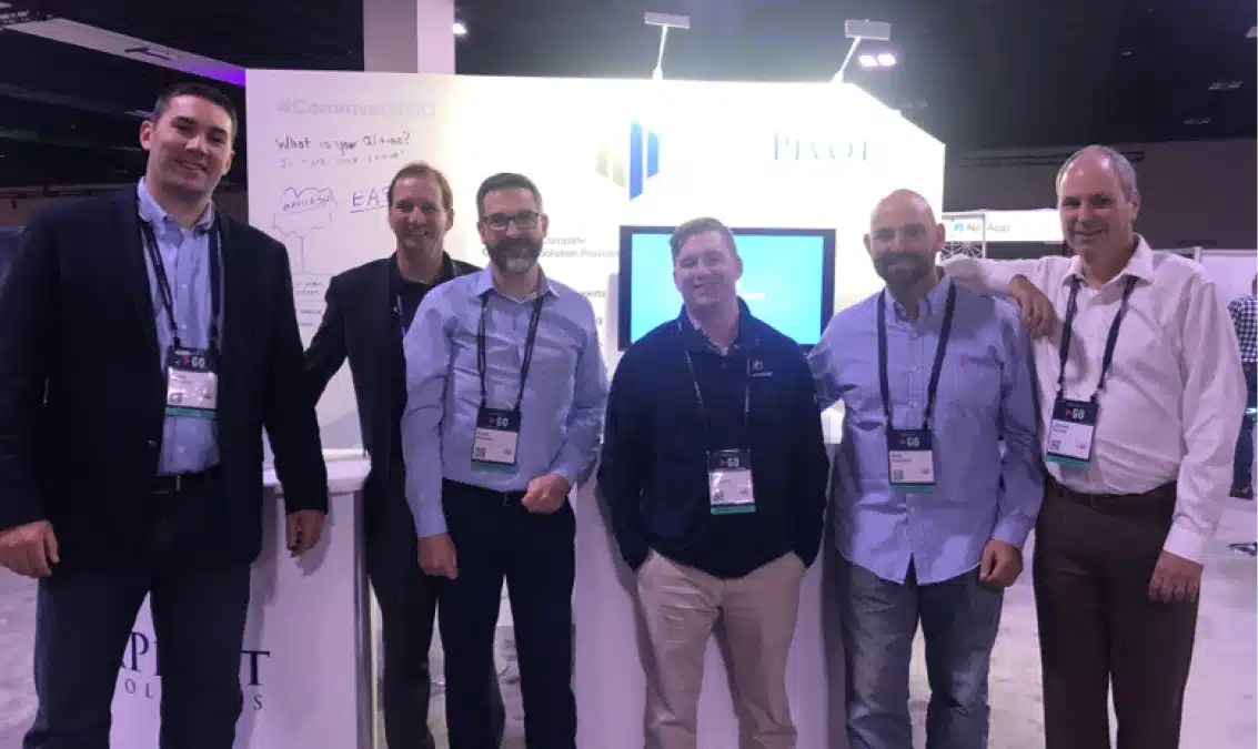 DataPivot Technologies team smiling and posing together during an industry technology conference