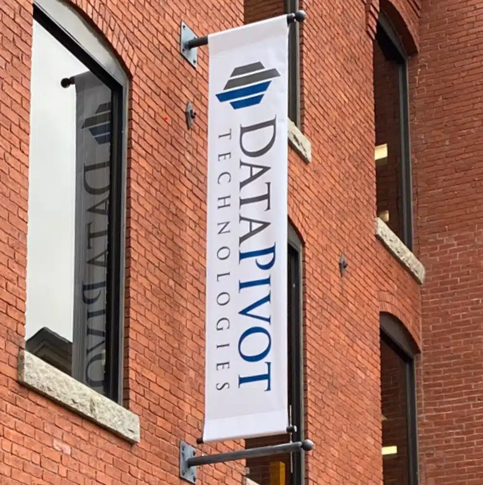 DataPivot Technologies branded banner displayed prominently on a classic red brick office building