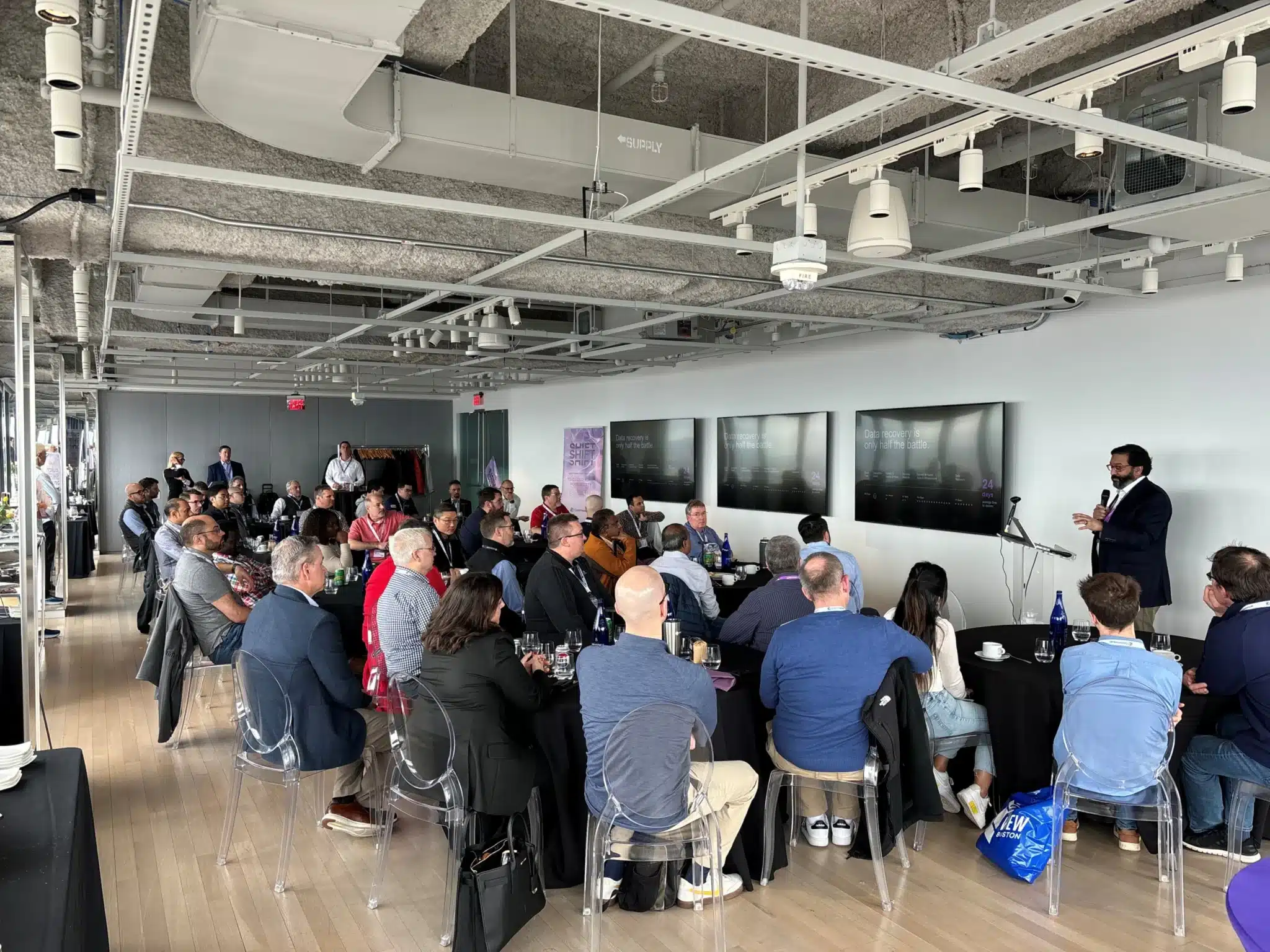 Conference room filled with attendees watching speaker during SHIFT Boston cyber resilience event